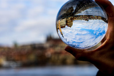 Close-up of human hand holding crystal ball