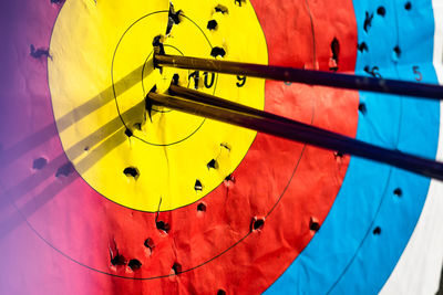 Low angle view of multi colored umbrella against blue sky