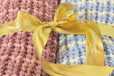 Close-up of knitted fabrics tied with ribbon