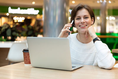 Smiling woman talking on smart phone