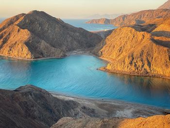 Scenic view of lake and mountains against sky