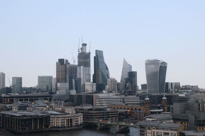 Modern buildings in city against clear sky