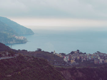 High angle view of sea and cityscape against sky