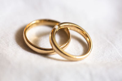 Close-up of wedding rings on textile