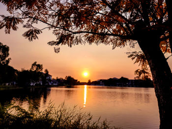 Scenic view of lake against orange sky