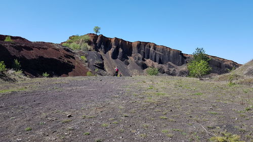Rock formations on landscape against clear sky