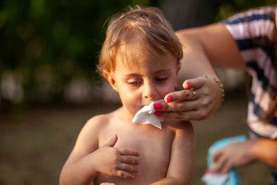 Boy holding baby girl