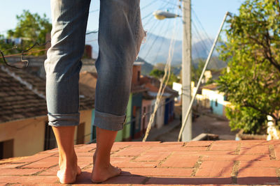 Close-up of female feet on the roof