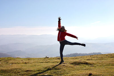 Man standing on mountain against sky