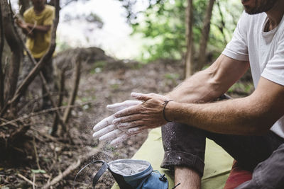 Close up of rock climber hands clapping hands with chalk