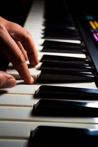 Midsection of man playing piano