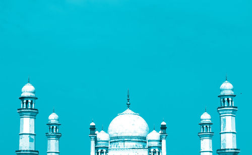 High section of mosque against clear blue sky