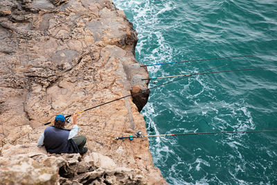 High angle view of man fishing in sea