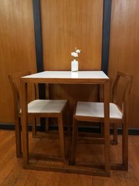 Empty chairs and table against wall at home