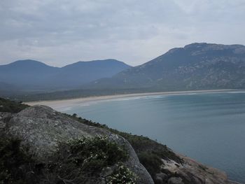 Scenic view of lake and mountains against sky