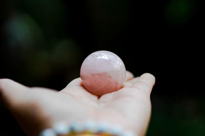 Close-up of hand holding crystal ball