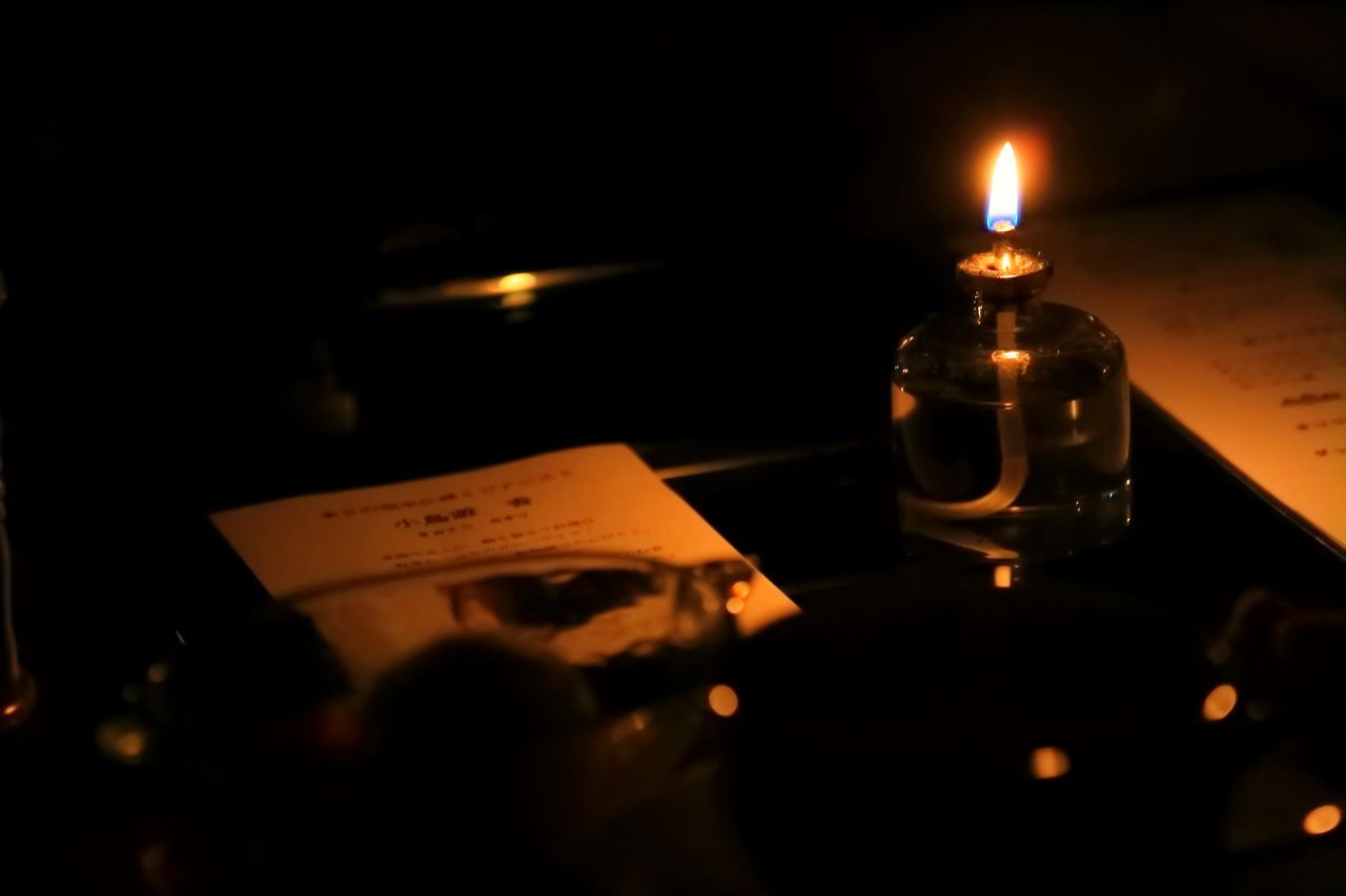 indoors, illuminated, table, candle, drink, close-up, burning, food and drink, flame, still life, alcohol, lit, wineglass, refreshment, heat - temperature, glass - material, lighting equipment, darkroom, candlelight, drinking glass