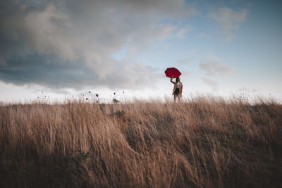 Man standing on field against sky