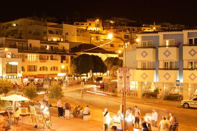 People on road in city at night