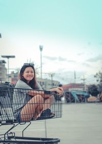 Portrait of smiling young woman sitting outdoors