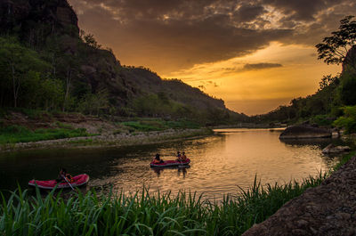 Scenic view of river against sky during sunset