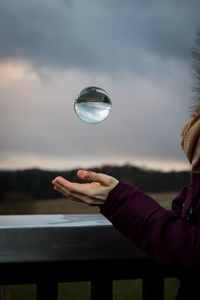 Cropped hand of woman holding crystal ball