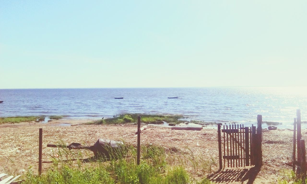 sea, horizon over water, beach, tranquil scene, scenics, water, clear sky, tranquility, nature, railing, outdoors, copy space, beauty in nature, day, no people, sand, blue, sky