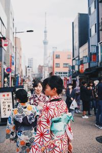 People standing on street in city