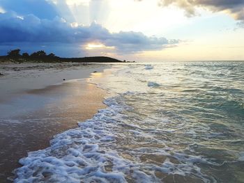 Scenic view of beach against sky during sunset