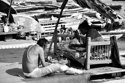 People sitting at market stall