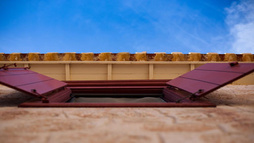 Close-up of food on wall against blue sky