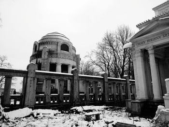 Abandoned building against clear sky during winter