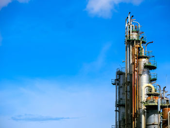 Low angle view of factory against blue sky