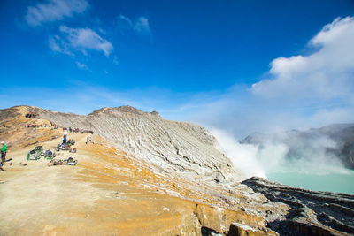 Scenic view of hot spring against sky