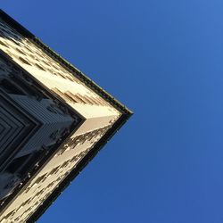 Low angle view of building against clear blue sky