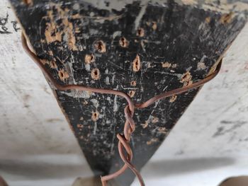 High angle view of rusty metal on wood