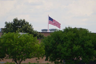 Low angle view of american flag against sky