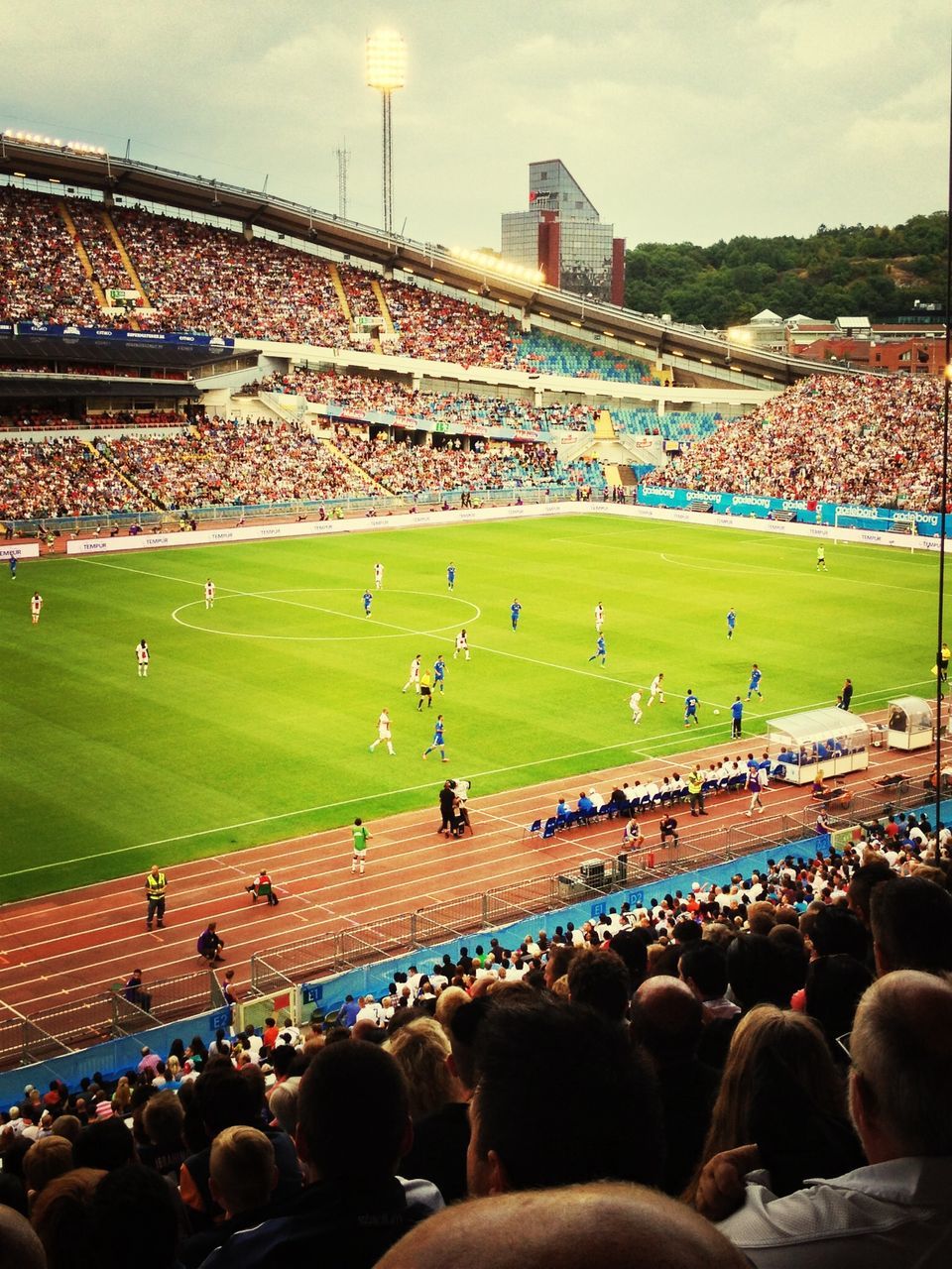 large group of people, crowd, men, person, architecture, built structure, lifestyles, leisure activity, building exterior, mixed age range, tourist, high angle view, stadium, tourism, grass, sport, sky, travel destinations