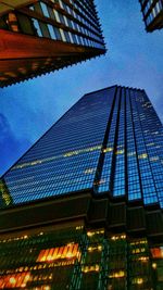 Low angle view of modern building against blue sky