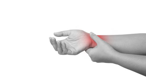 Close-up of woman hand over white background