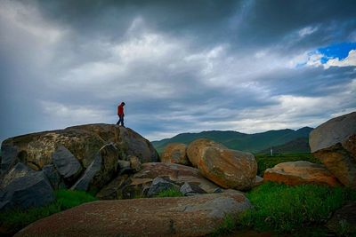 Scenic view of mountains against cloudy sky