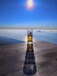 Lighthouse by sea against sky