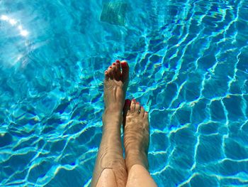 Low section of woman swimming in pool