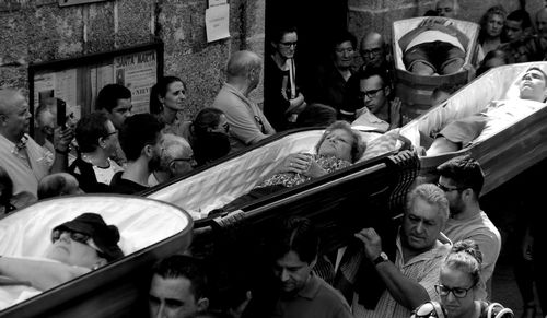 High angle view of crowd carrying people in coffins during fiesta de santa marta de ribarteme