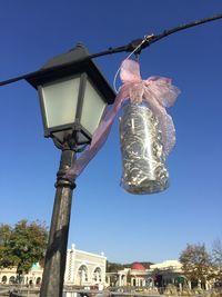 Low angle view of lamp post against clear blue sky