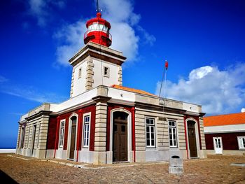 Low angle view of red building against blue sky