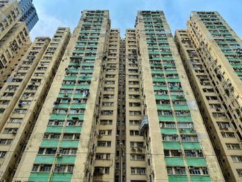 Low angle view of modern buildings in city against sky