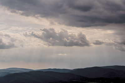 Scenic view of mountains against dramatic sky