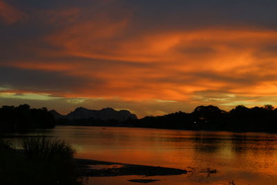 Scenic view of lake against orange sky