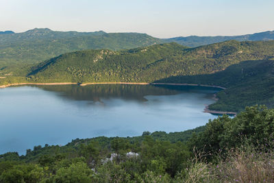 Scenic view of lake and mountains against sky